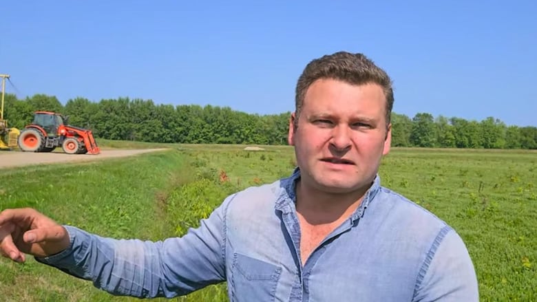 A man points at a field