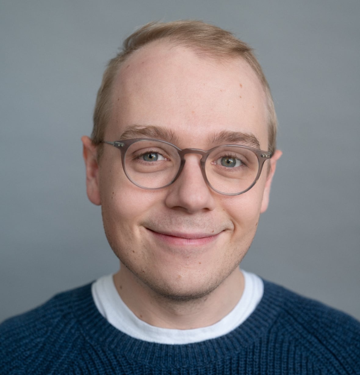 A man smiles at the camera