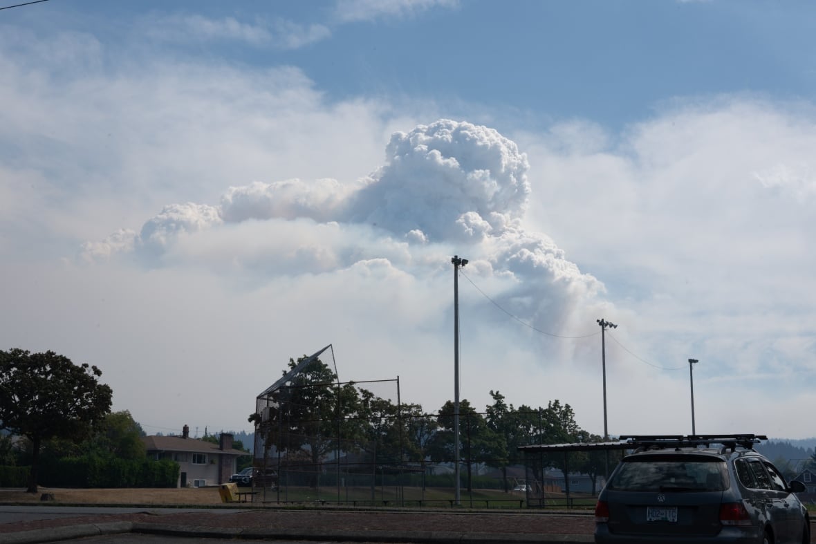 A large cloud formation is seen above a baseball diamond.