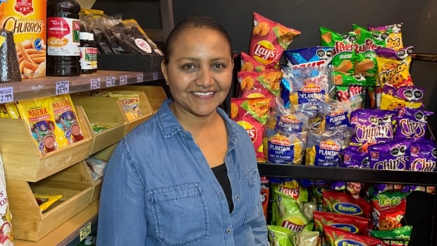 Sandra Zahuna is the owner of San's Latin Market. Sandra Zahuna poses in front of Latin snack products at her store, San's Latin MArket