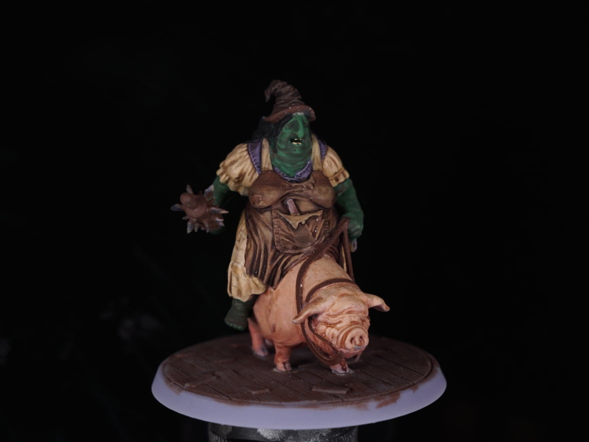 A miniature of an ogre riding a pig like a donkey