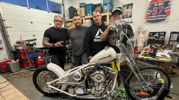 Men building motorcycle
