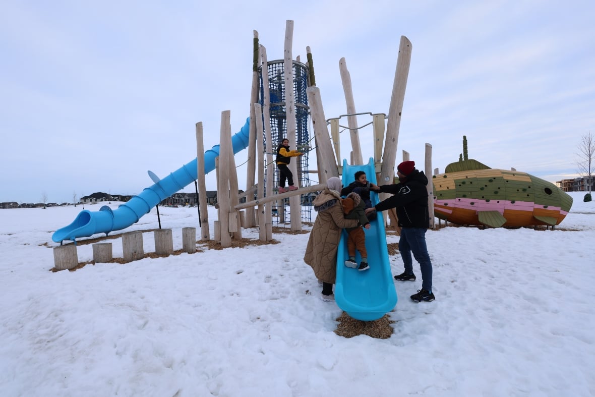 Zakot and his wife play with their three children. The family experienced snow for the first time after moving from Gaza to Calgary.