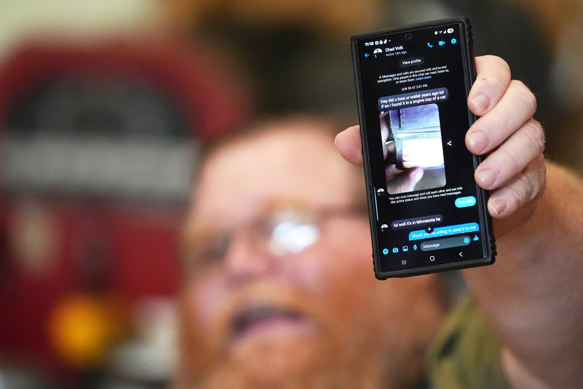 Richard Guilford holds up a chat message he received from Chad Volk during an interview Thursday, Aug. 14, 2025, in Petersburg, Mich. 