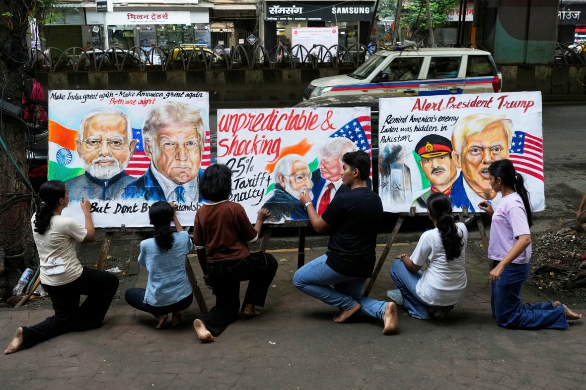 People kneel in the streets and draw three protests that include US President Donald Trump, India Prime Minister Narendra Modi and protest slogans against definitions.
