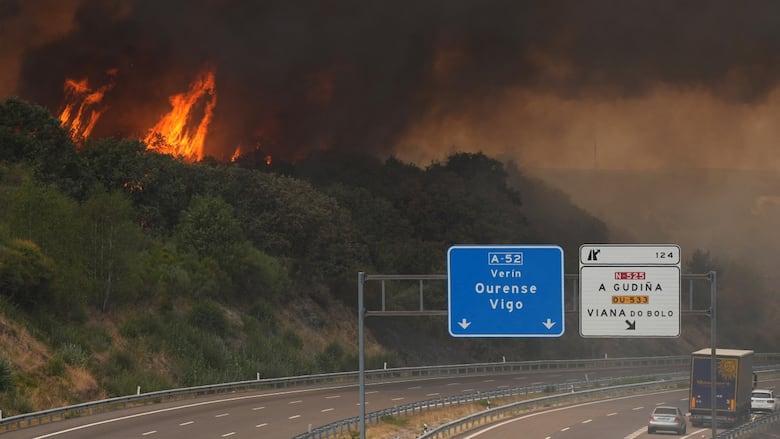 A wildfire burns near a highway in northwestern Spain, on Aug. 15, 2025.