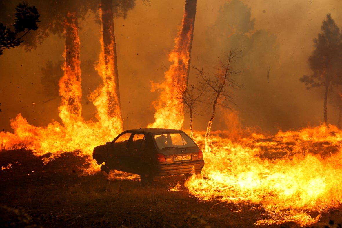 A car is burning during the wildfires in Mida, Portugal, in August 2025.