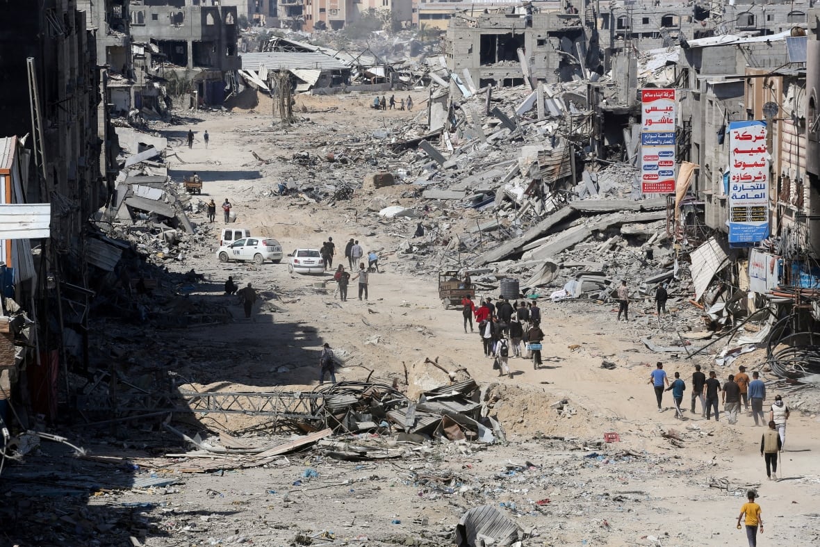 In one of Zakot's last photographs from the ground, Palestinians inspect destroyed residential buildings, after the Israeli military withdrew most of its ground troops from the southern Gaza Strip in Khan Younis, in the southern Gaza Strip, on April 7, 2024. 