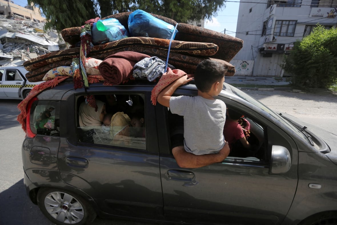 Palestinians flee their houses heading toward the southern part of Gaza Strip after Israel's call for more than 1 million civilians in northern Gaza to move south within 24 hours, amid the Israeli-Palestinian conflict in Gaza City, October 13, 2023.