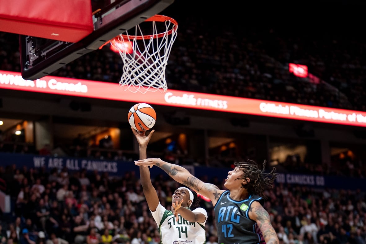 Seattle Storm's Dominique Malonga (14) lays up as Atlanta Dream's Brittney Griner (42) defends during the first half of a WNBA basketball game in Vancouver, B.C., on Friday, August 15, 2025.