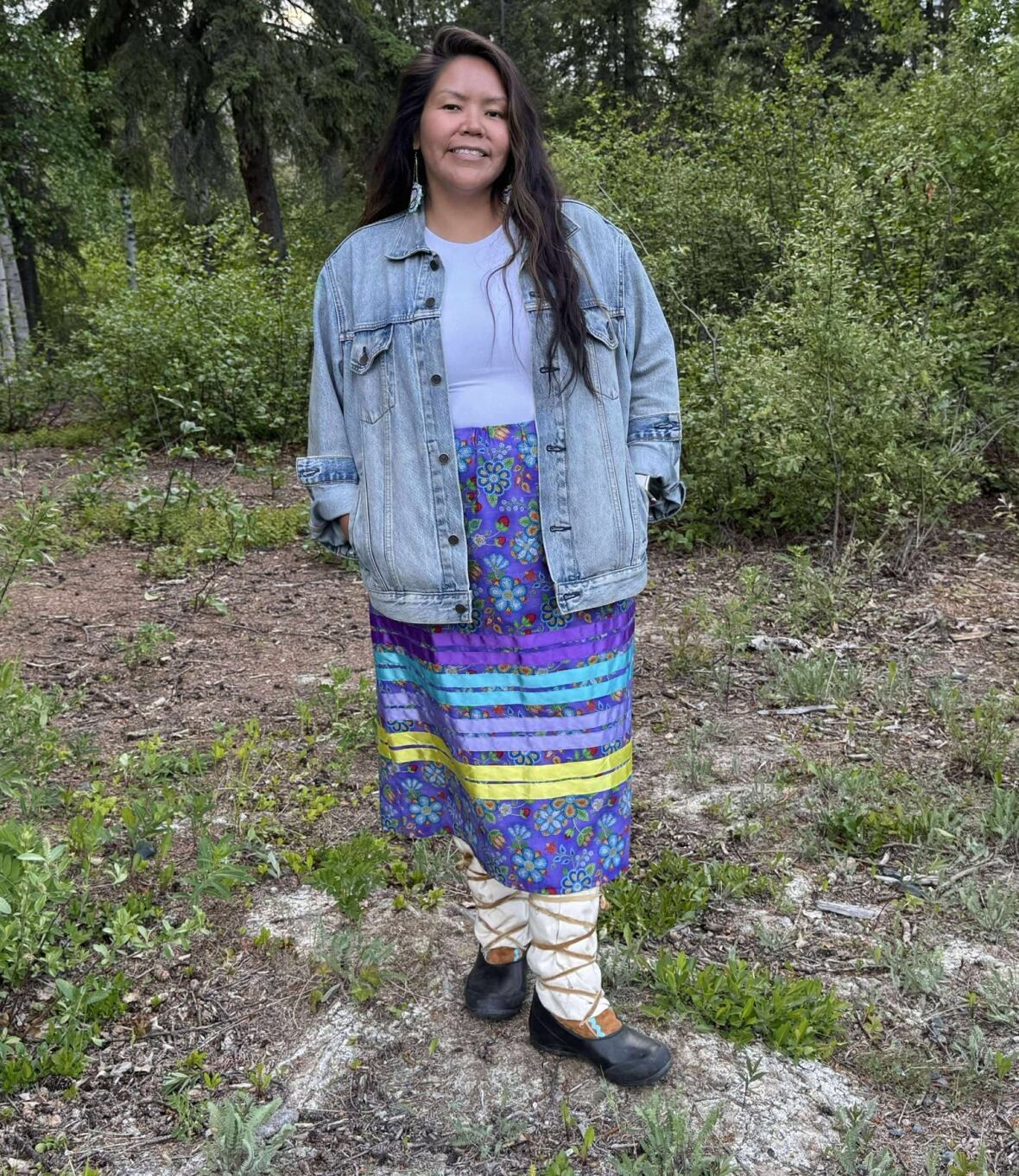A woman stands outside.