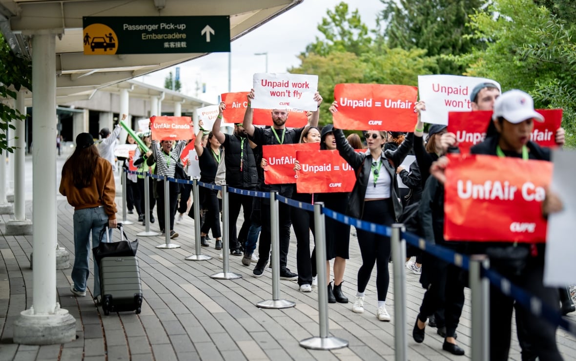 People holding signs demonstrate.