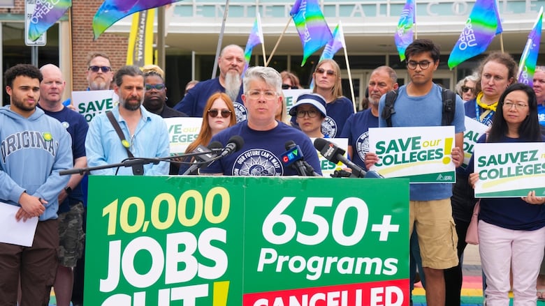 JP Hornick, President of OPSEU/SEFPO, stands with supporters outside of Centennial College in Toronto.