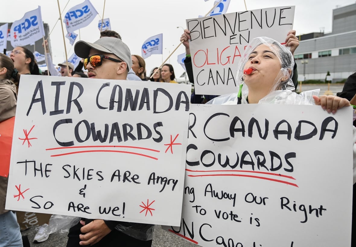 Air Canadian employees and union members protest outside the Air Canada headquarters.