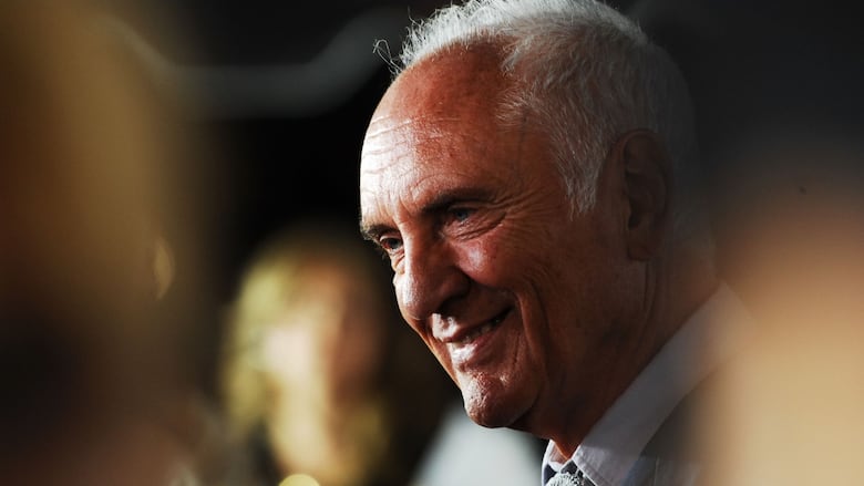 A person smiles while being interviewed.