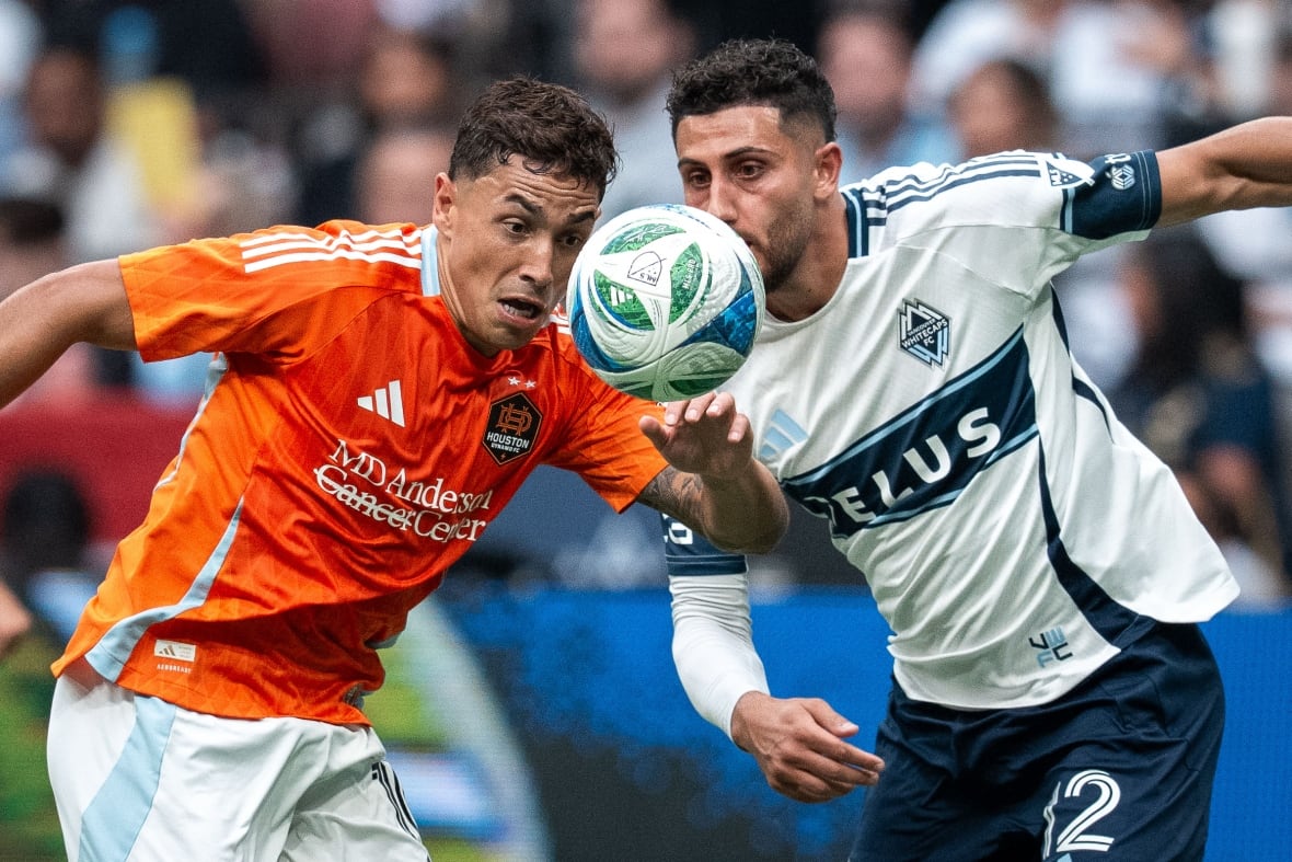 Two athletes vie for the ball during the game.