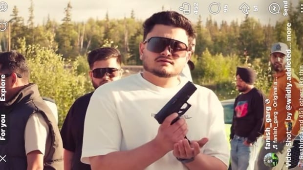 Man holds evident  manus  weapon  successful  beforehand   of camera