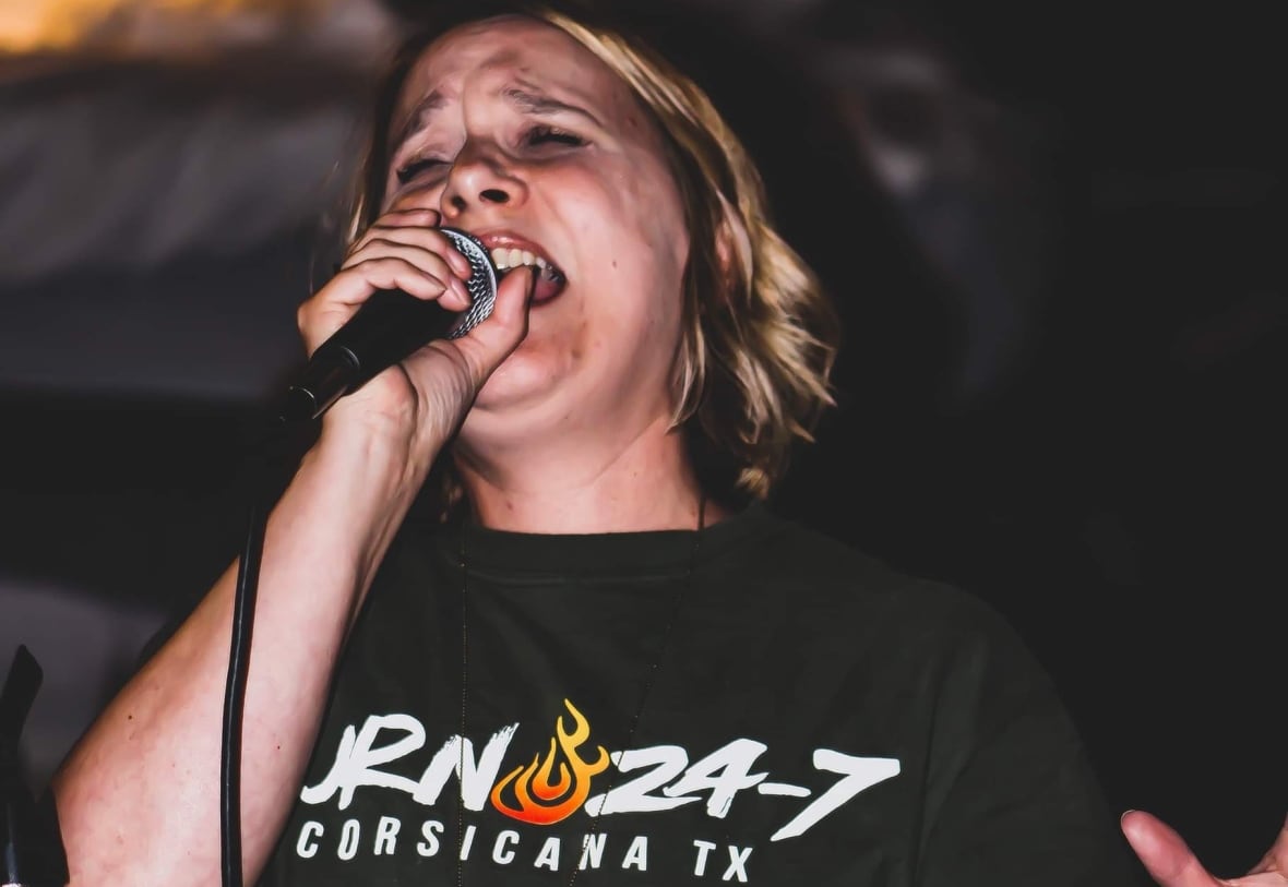 A woman holding a microphone.