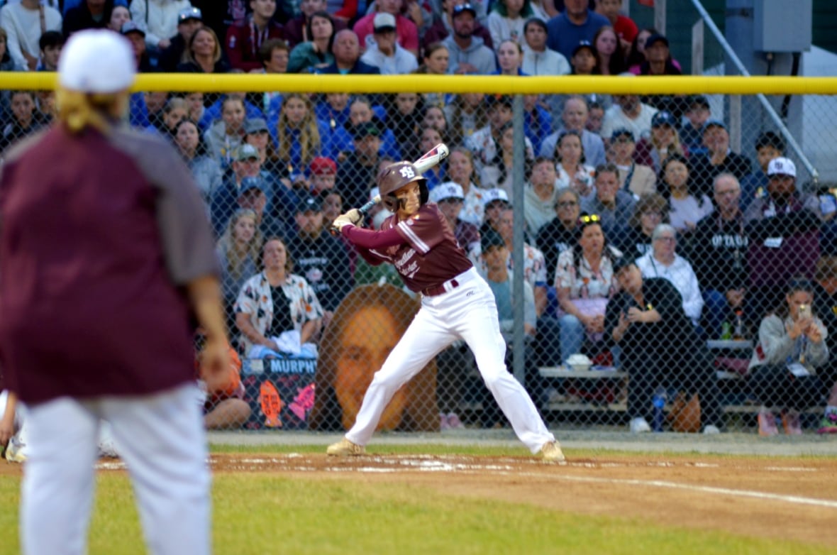 A girl playing baseball. 