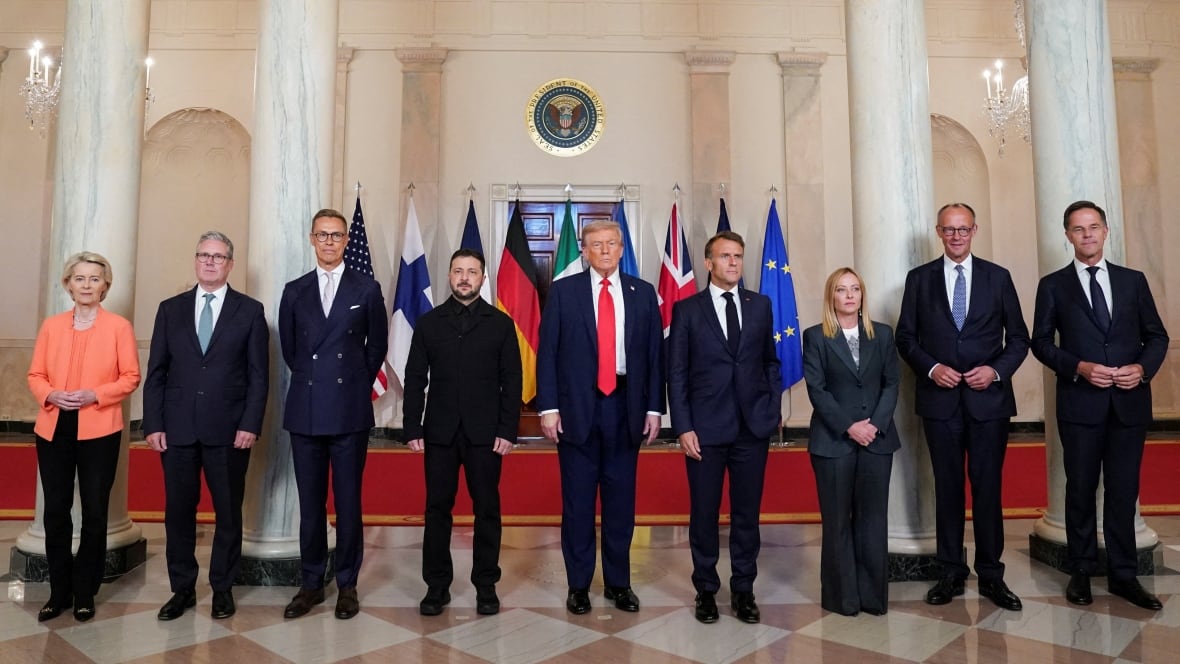 Politicians stand in a row.