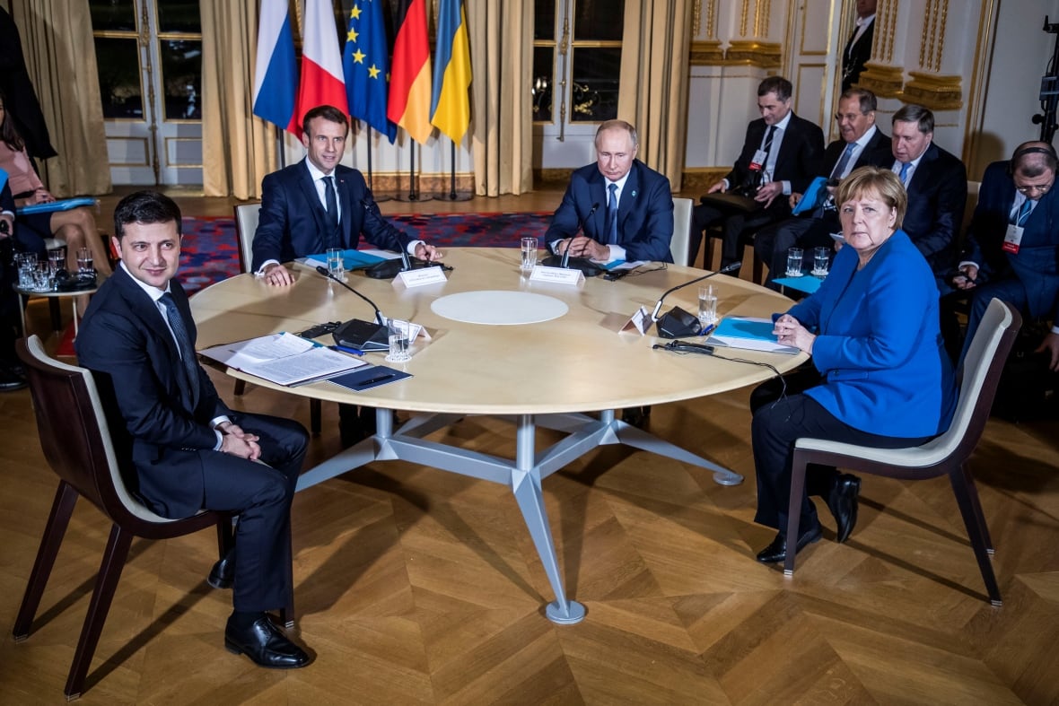 Ukrainian President Volodymyr Zelenskyy, German Chancellor Angela Merkel, French President Emmanuel Macron and Russian President Vladimir Putin attend a working session during a summit on the conflict in Ukraine at the Elysee Palace in Paris, France December 9, 2019. 