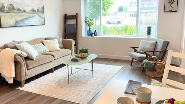 Need help buying a home? Why one non-profit says you'll need to earn more to qualify | CBC News