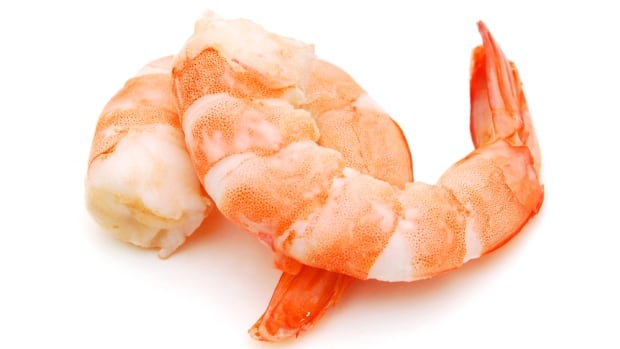 Two cooked unshelled tiger shrimps isolated on white. Two cooked unshelled tiger shrimps isolated on white.