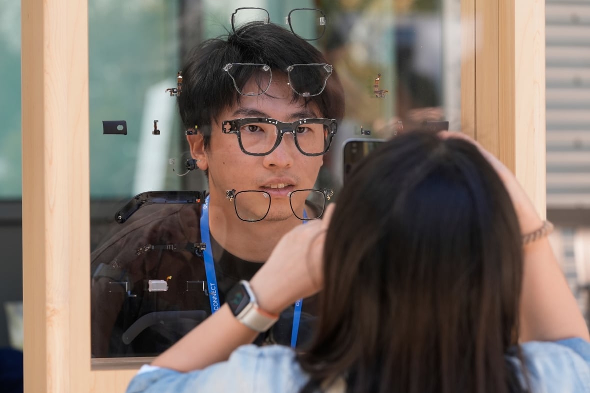 A person looks through a display with different glasses prototypes.