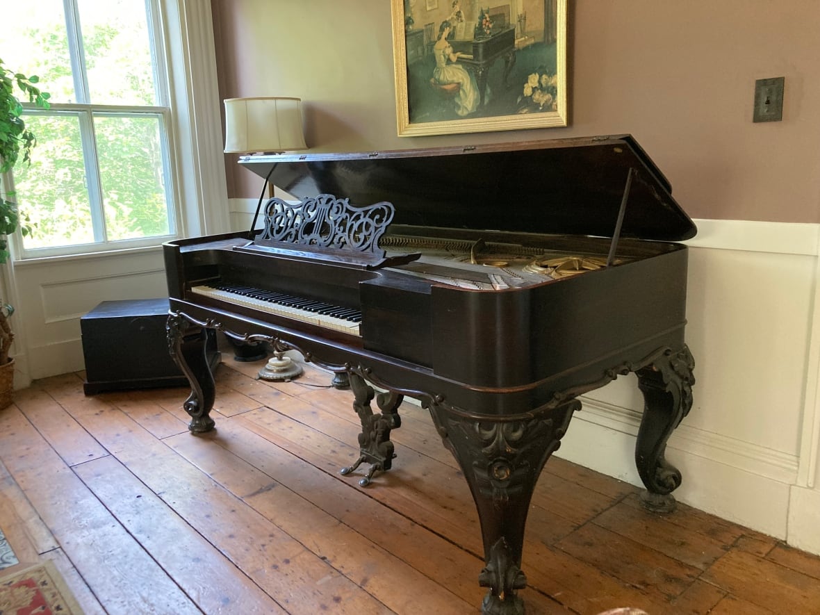 An old, vintage piano against a wall