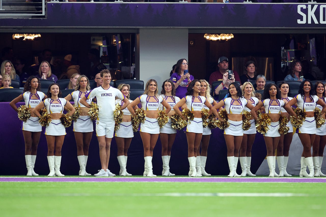 Minnesota Vikings cheerleader Louie Conn leads the crowd during the third  quarter against the New England Patriots at U.S. Bank Stadium in  Minneapolis on Aug. 16, 2025.