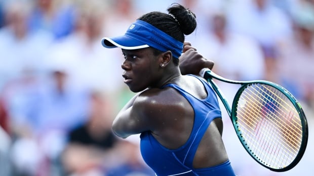 After her stunning victory at the Canadian Open, Vicky Mboko heads to New York for her U.S. Open debut. A women's tennis player hits a shot.