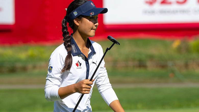 Canadian teenaged golfer Aphrodite Deng waves to the crowd with her putter on the 12th green in the first round of the Canadian Women's Open at Mississauga Golf and Country Club in Ontario on August 21, 2025.
