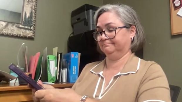 Krista Tucker holding a smartphone
