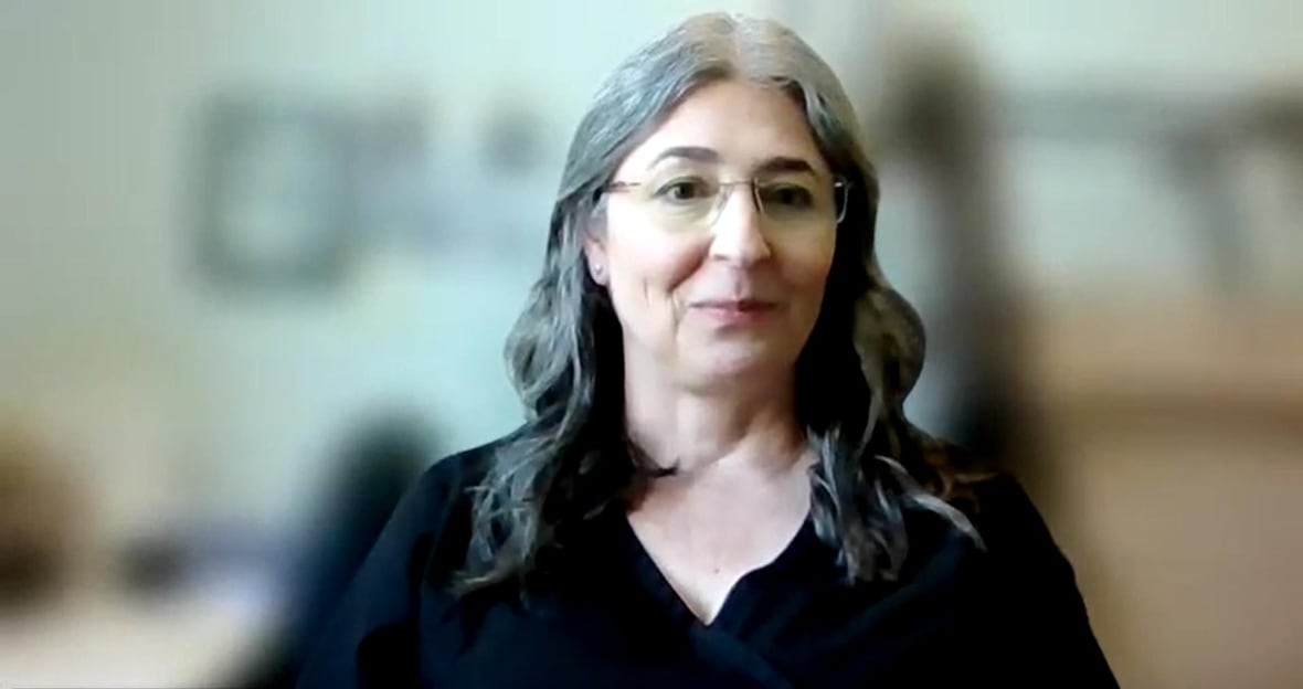 A woman speaks on Zoom
