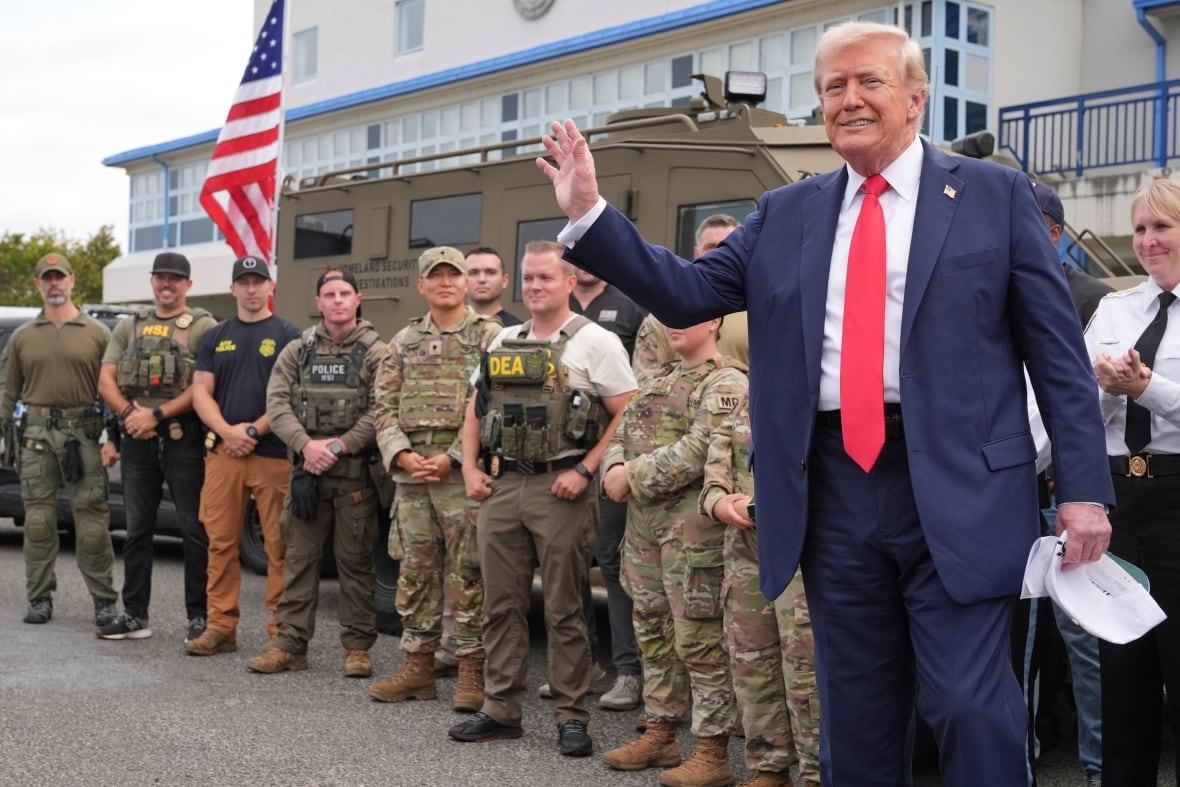 A person while standing in front of a line of soldiers.