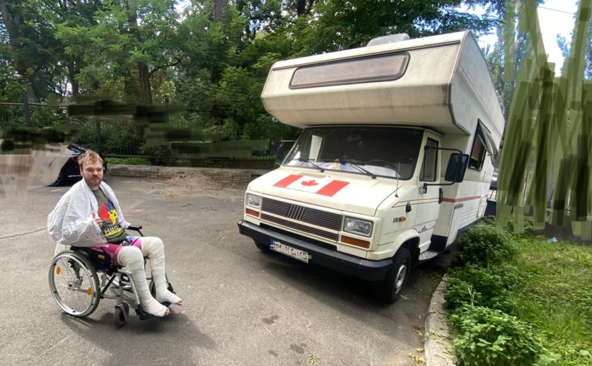 Mc Hughes sits outside the hospital in Kiev near a mobile housing vehicle donated that his father was living in him while Hughes recovered in the hospital. 