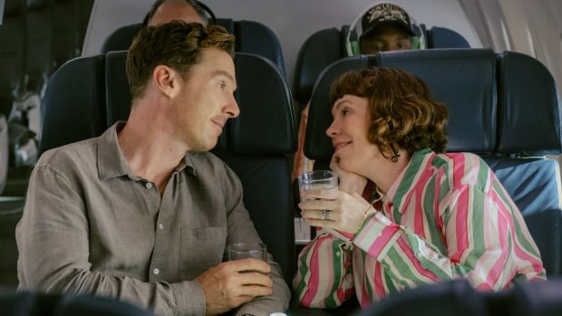 A grinning man and woman look longingly into one another's eyes. 