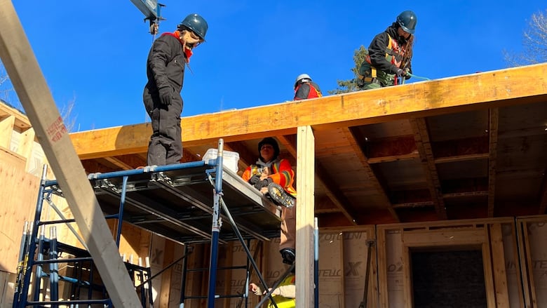 Women constructing a home. 