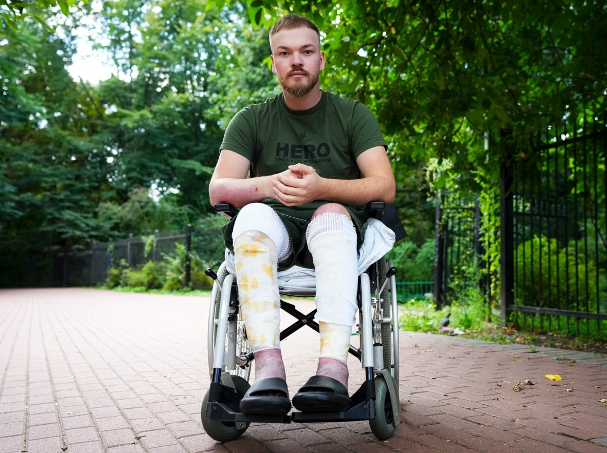A green man is photographed on a wheelchair.