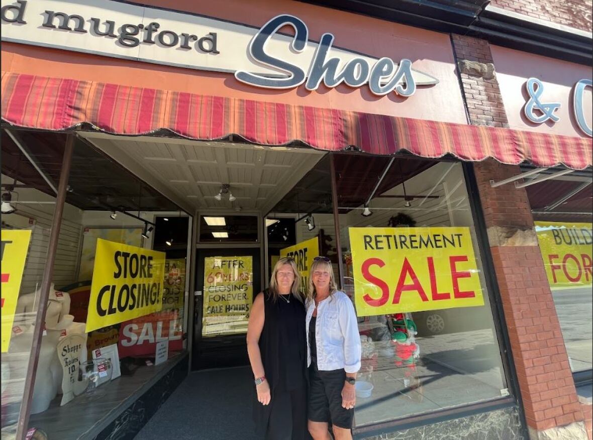 Patti Mugford, left, and her sister Jodi in front of the store at 429 Talbot St., which is now for sale. 