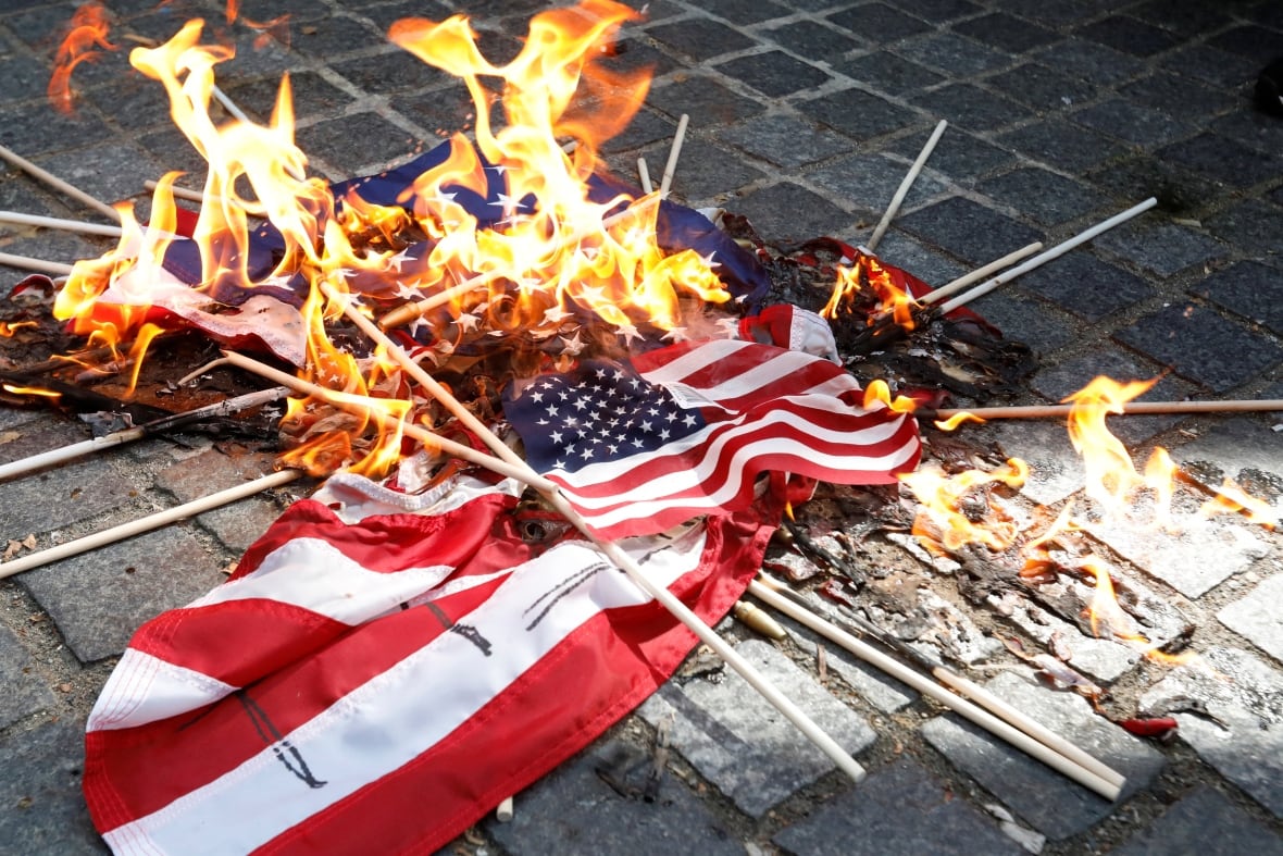 Heaps of red flags, white and blue burning 