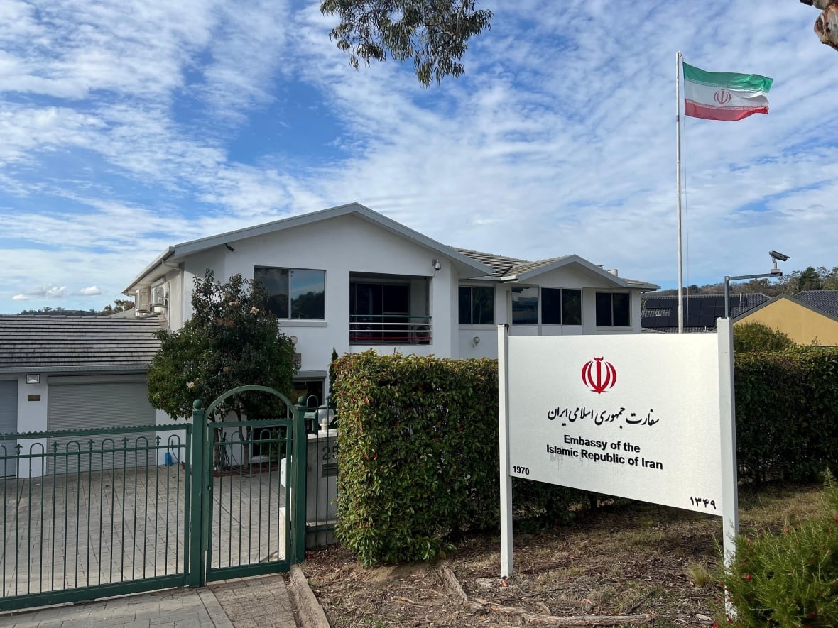A low -height building appears similar to residence with a large flag. 