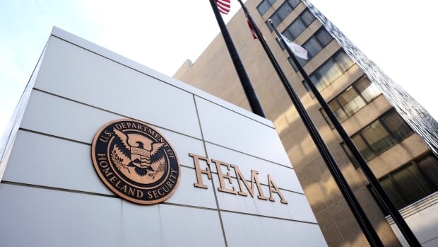 The side of a white building with a sign reading F-E-M-A and a seal reading Department of Homeland Security