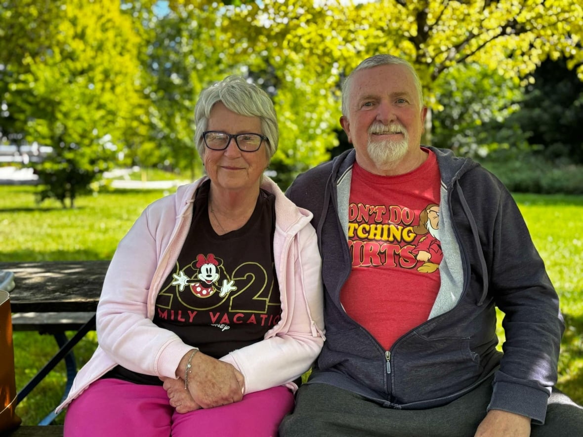 A couple sits at a park