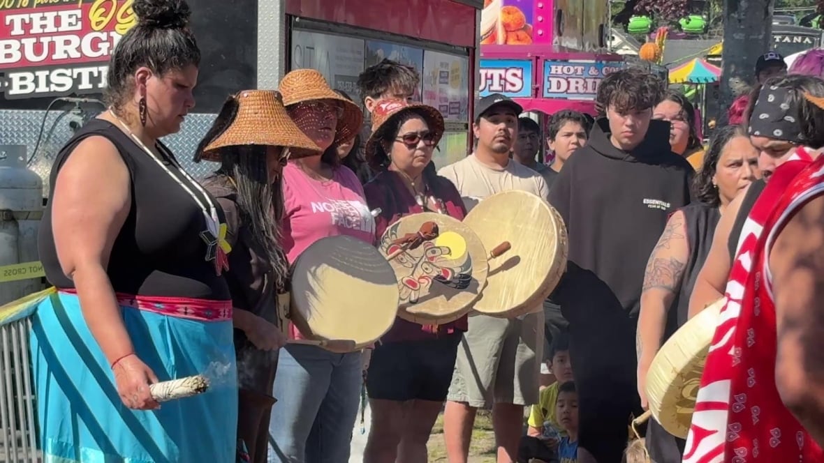 People hold their heads and drum.
