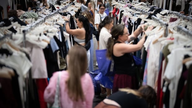 People browsing clothing racks.