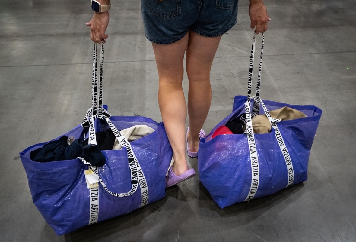 A person dragging shopping bags.