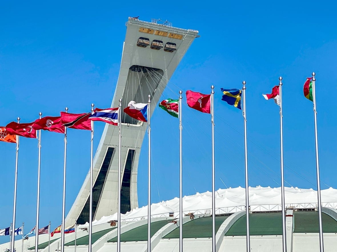 Flags from around the world encircle the Montreal Olympic Stadium.