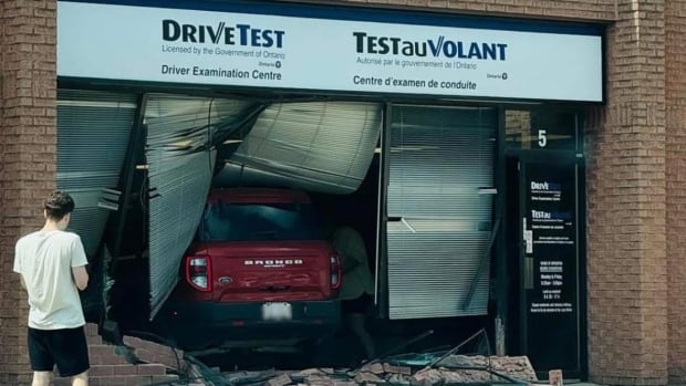 Sarnia police say the crash happened just before 3 p.m. on Wednesday, and no one was seriously hurt. A building with a red Ford Bronco through it.