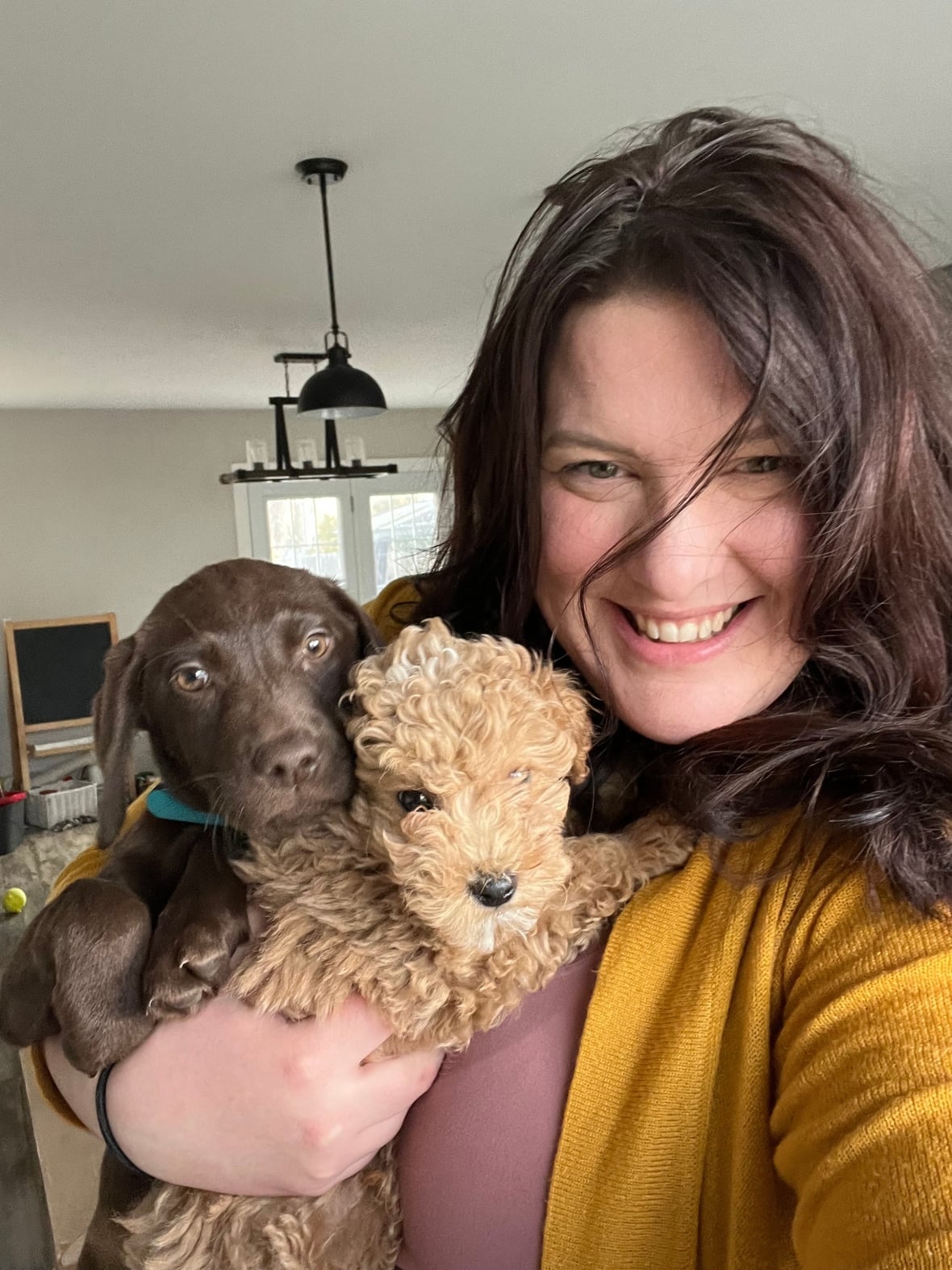 Michelle Black-Sullivan with two small dogs.